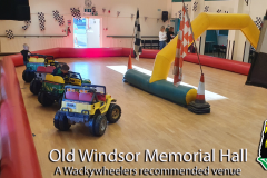 Mini electric Jeeps lined up inside Old Windsor Memorial Hall