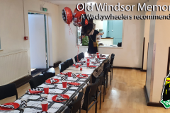 Long birthday party dining table inside Old Windsor Memorial Hall