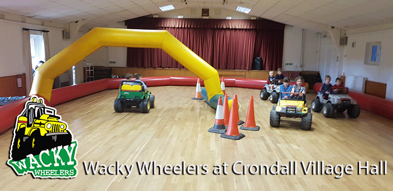 Children having fun driving mini jeeps at a boy's party in Crondall Village Hall