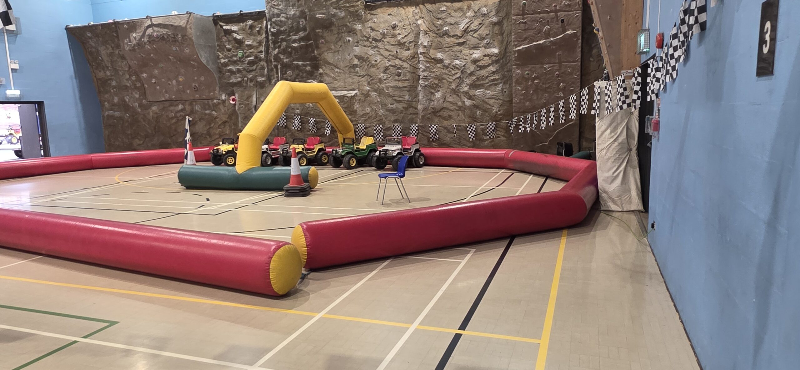 Inflatable Wacky Wheelers driving track and Jeeps set up inside Sunbury Leisure Centre sports hall