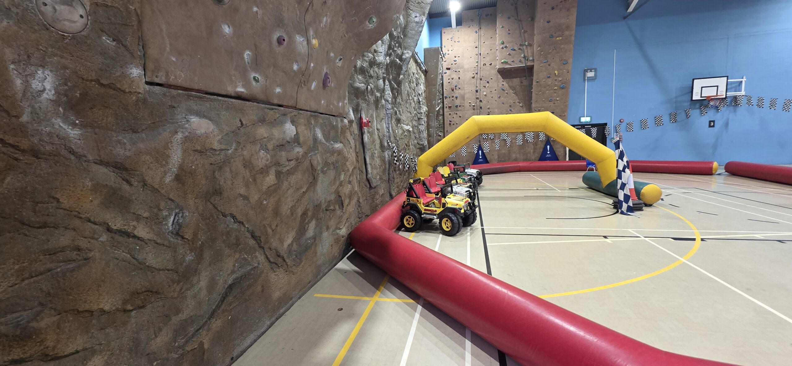 Wacky Wheelers ride-on Jeeps beside the inflatable track and climbing wall at Sunbury Leisure Centre
